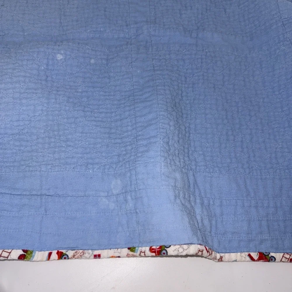 Vtg Baby Quilt Of Trains Print bordered by blue sashing and red cornerstones